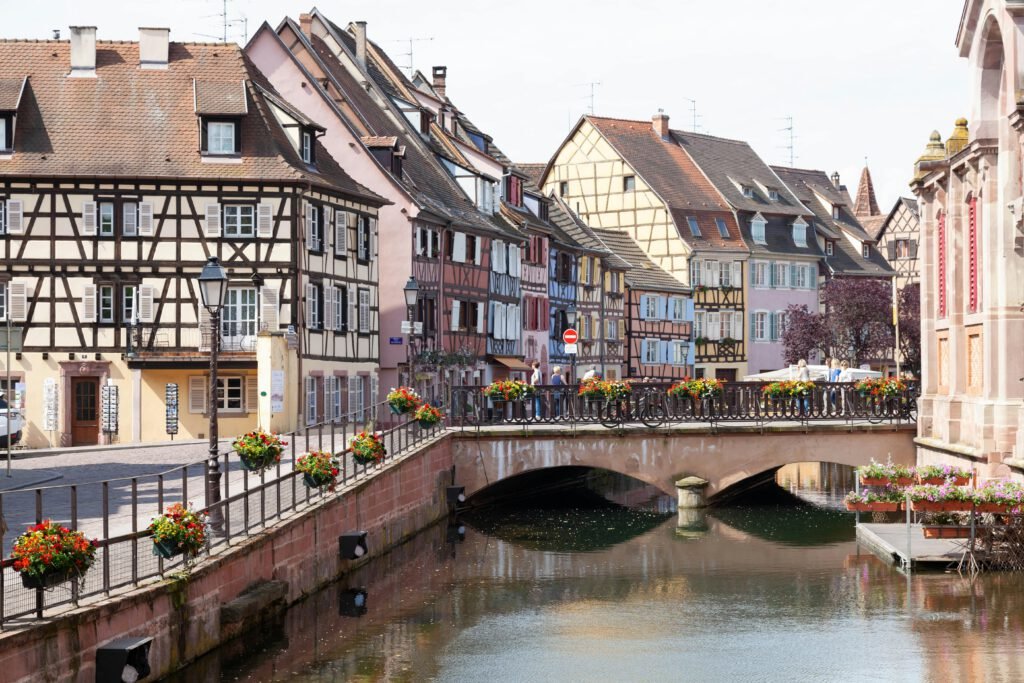 pexels photo 18249236 18249236 Scenic view of Colmar's half-timbered houses and picturesque bridge over a peaceful canal.