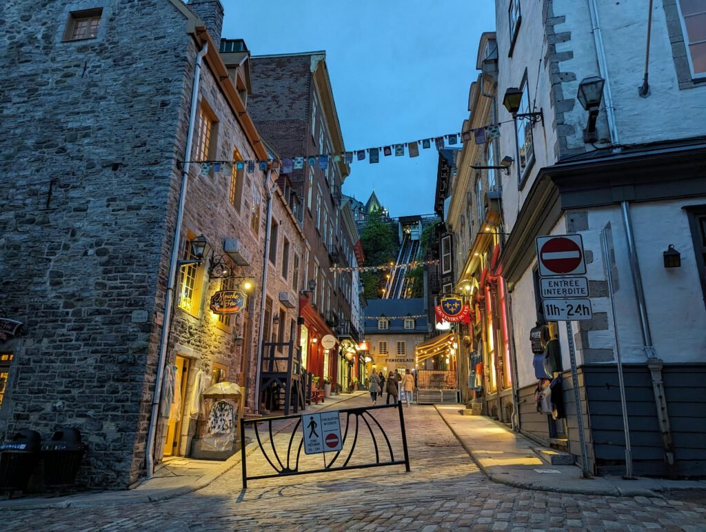 pexels photo 25905453 25905453 Charming illuminated street in Old Québec City captured in the evening, showcasing historic architecture.
