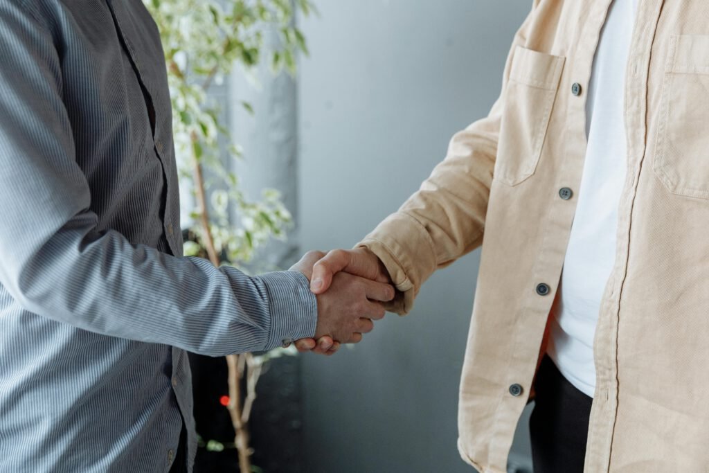 pexels photo 7653971 7653971 A close-up image of two businesspeople shaking hands in an office environment symbolizing agreement and partnership.