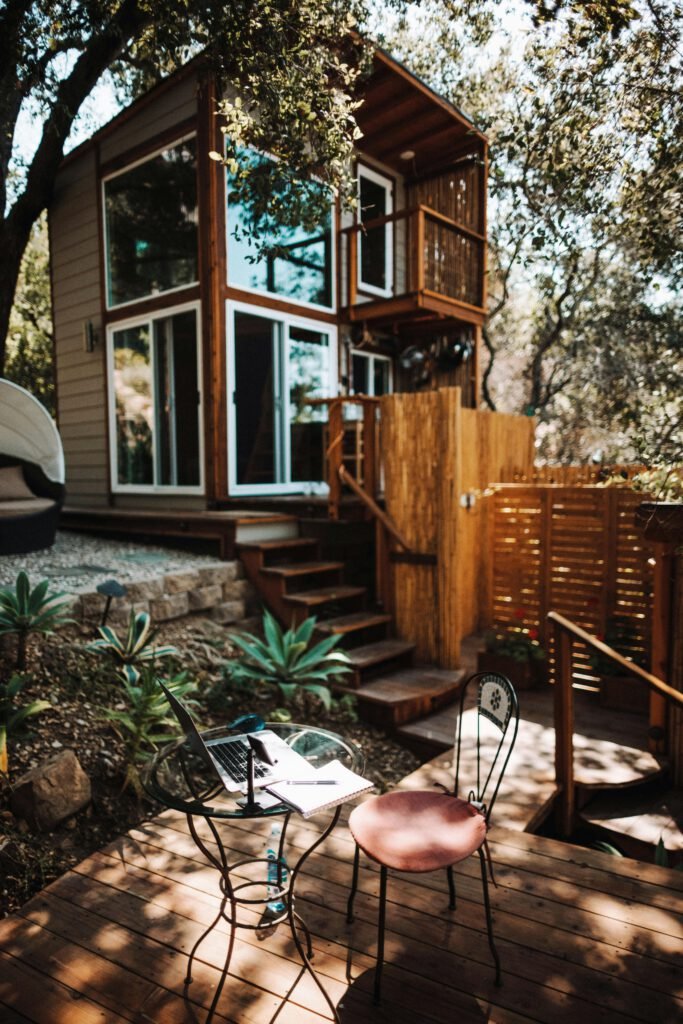 pexels photo 8755444 8755444 A tranquil outdoor workspace in Topanga, featuring a laptop, chairs, and lush greenery.