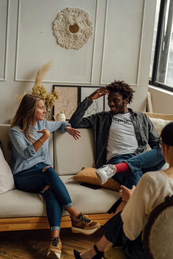 Two people enjoying a relaxed conversation in a modern living room setting.