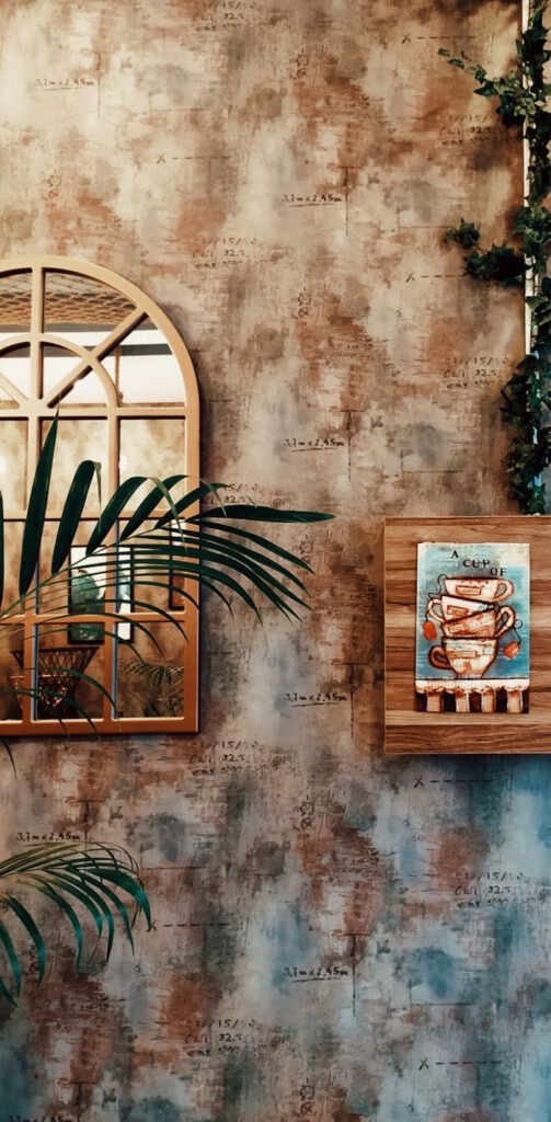 Stylish wall decor featuring a mirror and artistic coffee-themed painting, perfect for home interiors.